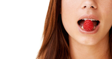 Image showing Health, mouth and closeup of woman with raspberry in a studio for detox, vegan diet and fresh ingredient. Wellness, nutrition and face of young female model with organic fruit by white background.