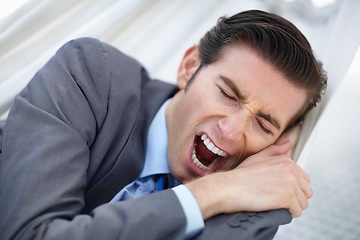 Image showing Sleeping, yawn and tired business man in a hammock with low energy, resting or break outdoor. Sleepy, face and young male entrepreneur outside with fatigue, nap or travel burnout, lazy and dreaming