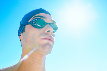Image showing Swimmer, sky and face of sports man determined for exercise, outdoor workout or training routine. Swimwear, sunshine or athlete with cap, goggles and commitment to summer challenge, fitness or cardio