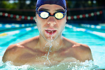 Image showing Athlete man, swimming pool and fitness with splash, speed or exercise for wellness, health or sport. Swimmer, closeup and person in water for training, contest or workout with goggles in summer games