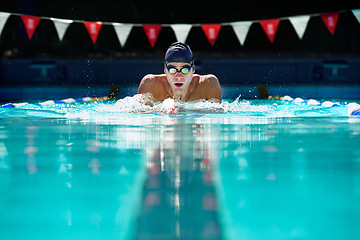 Image showing Man, swimming pool and exercise for sport with splash, speed and training for wellness, health and fitness. Swimmer, athlete or person in water for games, contest or workout with goggles in summer