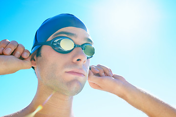 Image showing Swimming, blue sky and face of sports man determined for exercise, outdoor workout or training routine. Swimwear, sunshine and person with cap, goggles and getting ready for active cardio practice