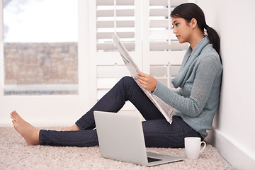 Image showing Newspaper, reading news and woman in a home with article, paper and press media for research. Morning, writer and remote work of an Indian female person with coffee and laptop for writing in a house