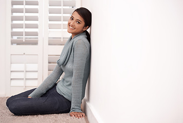 Image showing Woman, portrait and smile in a new home on the floor and carpet relax in the morning. Lounge, happy and female person from India with mockup space, real estate and calm in a house by a room wall