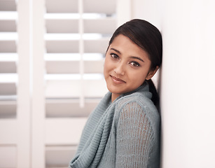 Image showing Woman, portrait and smile in a new home on the floor and carpet relax in the morning. Lounge, happy face and female person from India with living room, real estate and calm in a house by a wall