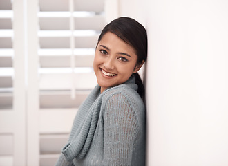 Image showing Indian woman, portrait and smile in a new home relax in the morning. Lounge, happy and female person face with mockup space, real estate and calm in a house leaning on a room wall in a bedroom