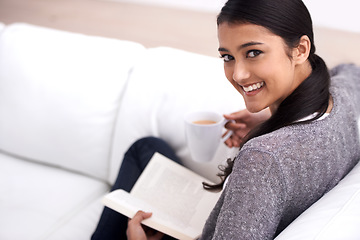 Image showing Woman, book and coffee on sofa for reading, learning and education in literature, language or knowledge. Portrait of Mexican student, relax with tea and living room with novel, fiction or happy story