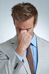 Image showing Businessman, headache and stress in studio for debt, mental health and bankrupt or burnout. Male person, migraine and frustrated by white background, deadline and depression or mistake and tension