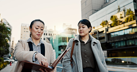 Image showing Documents, walking and Japanese business people in city for morning commute, travel and discussion. Collaboration, corporate team and women with paperwork for meeting, talking and project in Tokyo