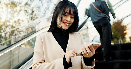 Image showing Smartphone, happy and Japanese woman on escalator in city, social media app or reading email notification on internet technology in Tokyo. Phone, mobile and person smile outdoor to travel or commute