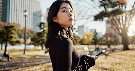 Image showing Japanese, woman and smartphone in park, travel and communication with social media and adventure. Texting, email and online chat with connectivity, mobile app and outdoor for fresh air in Tokyo