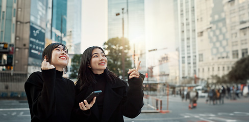 Image showing Phone, friends and women pointing in city for travel, social media and connection together in Japan. Smartphone, girls and happy people in urban street outdoor to commute with digital app in Tokyo