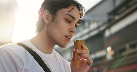 Image showing Ice cream, eating and Japanese man in city on vacation, holiday and adventure in Yokohama town. Travel, weekend trip and person with dessert, sweet snack and cone in street for tourism destination