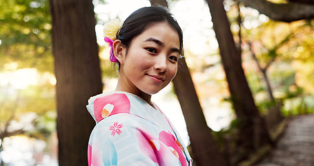 Image showing Japanese woman, portrait and kimono in forest with smile, pride and traditional clothes for culture on walk. Girl, person and happy with indigenous fashion, style or outdoor by trees, woods or nature