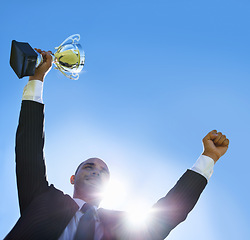 Image showing Winning, businessman and outdoor celebration with trophy, happiness and achievement of success. Career, goals and man with victory of award or prize on blue sky with pride and inspiration in business