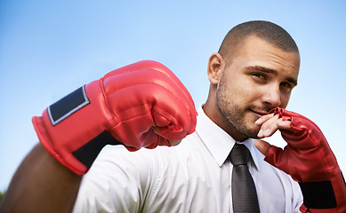 Image showing Business man, portrait and boxing gloves for fight or warrior, self defence and fitness for wellness. Male person, strong and equipment for power or corporate challenge, exercise and sky background