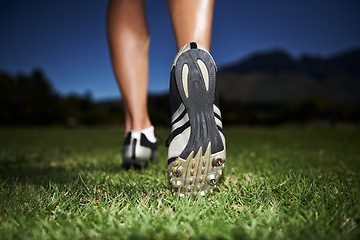 Image showing Person, feet and fitness at night for workout, exercise or outdoor cardio in health and wellness in nature. Closeup of athlete legs, walking or running on green grass in the late evening for training