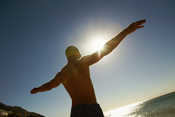 Image showing Beach, sky and sports man for swimming exercise, nature workout or outdoor practice in water, sea or island. Freedom, sunset and back of athlete for challenge, fitness or cardio with Hawaii fresh air