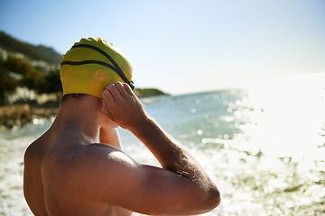 Image showing Sea, beach and man for swimmer exercise, nature workout or outdoor practice in ocean, sea or water waves. Swimwear, swimming cap and athlete prepare to start challenge, fitness performance or cardio