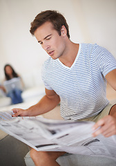 Image showing Man, reading and newspaper for morning information at home for global events, knowledge or politics. Male person, couch and print media discussion or worldwide crisis problem, international or report