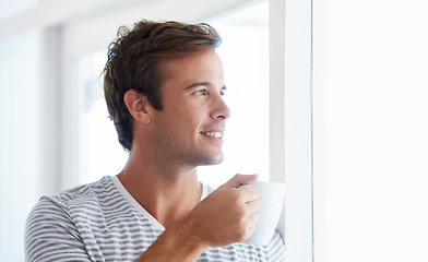 Image showing Man, coffee and thinking by window in morning with smile, vision or idea with drink, choice and remember in home. Person, tea cup and happy with view for memory, decision or relax on holiday in house