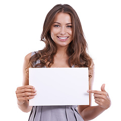 Image showing Paper, mockup and portrait of happy woman with hand pointing to space in studio on white background. Empty, poster and face of female model with presentation gesture, deal or platform, guide or offer