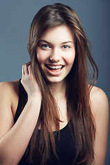 Image showing Hair, smile and face of woman for beauty, cosmetics and shine, salon hairstyle and grooming on grey background. Portrait, haircare and wellness with glow, skin and Brazilian treatment in studio