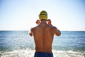 Image showing Sports, sea and back of man for swimming exercise, workout or training routine in beach, nature or water. Wellness, active and person ready to start challenge, fitness contest or triathlon practice