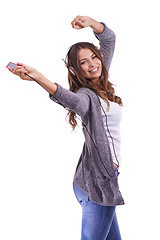 Image showing Happy woman, portrait and headphones dancing to podcast or music on a white studio background. Face of young female person smile with radio or audio player for sound track, podcast or streaming