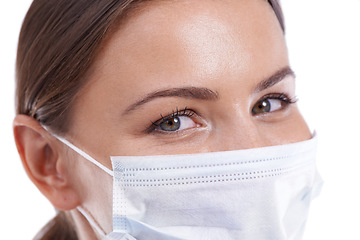 Image showing Healthcare, woman doctor and portrait with face mask in studio for safety from illness or bacteria on white background. Friendly, medical or eyes of nurse at hospital with cover for clinic compliance