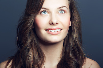 Image showing Woman, hair and natural beauty with cosmetic care, salon hairstyle and grooming on grey background. Happy, thinking with wellness and dermatology for skincare with growth and haircare in studio