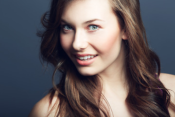 Image showing Portrait, natural beauty of woman and hair care in studio isolated on a blue background. Face, hairstyle and cosmetics of happy model at spa for facial treatment, wellness or skin health for glow