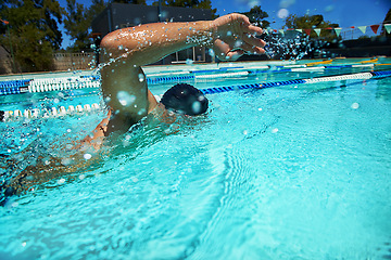 Image showing Summer, sport and athlete swimming in pool for competition, race or cardio training for triathlon. Fitness, workout and man exercise for health, wellness and practice stroke outdoor with water splash