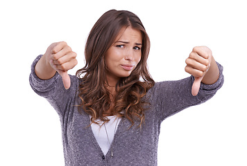 Image showing Thumbs down, portrait and unhappy woman in studio with rating for rejection, emoji sign or feedback of bad news on white background. Model show negative review, wrong decision and vote no for opinion