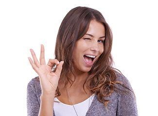 Image showing Ok, wink and portrait of woman in studio for vote, certified news and feedback on white background. Happy model blink with hand emoji for success, agreement and icon of excellence, review and support