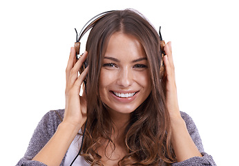 Image showing Happy woman, portrait and headphones listening to music, podcast or audio on a white studio background. Face of female person, brunette or model smile with headset for radio, streaming or songs