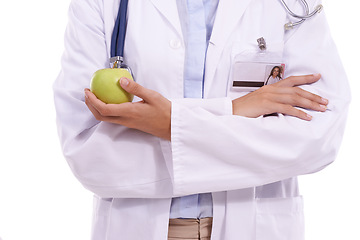 Image showing Woman, hands and doctor with apple in diet, natural nutrition or healthy snack on a white studio background. Closeup of female person, surgeon or medical employee with green organic fruit for vitamin