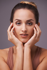 Image showing Portrait, skincare and wellness with natural woman in studio on gray background for dermatology. Beauty, aesthetic and cosmetics with hands of young person on face or skin for antiaging treatment