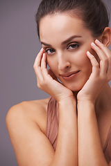 Image showing Portrait, beauty and aesthetic with natural woman in studio on gray background for wellness or dermatology. Skincare, makeup or cosmetics with hands of young person on face for antiaging treatment