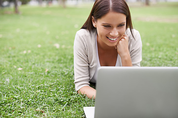 Image showing College student, studying and woman with laptop in park on campus with research, project and education. University, person and reading on computer outdoor on lawn, grass or garden with happiness