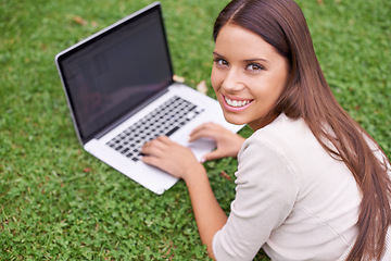 Image showing Woman, portrait and college student with laptop in park on campus with psychology research, project and education. University, person and typing on computer outdoor on grass in garden with happiness