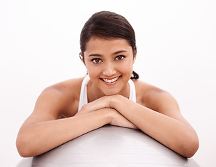 Image showing Studio, portrait and girl with gym ball, smile and exercise for health, wellness and training. Workout, pilates and happy woman with equipment for balance, fitness and body care on white background.