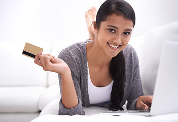 Image showing Happy woman, portrait and credit card with laptop for online shopping, purchase or payment on sofa at home. Young female person smile with debit in relax on computer for ecommerce, fintech or banking