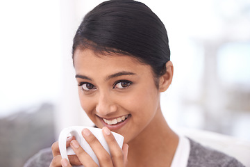 Image showing Coffee, happy and portrait of Indian woman in home for relaxing, comfortable and calm. Apartment, morning and face of person smile with mug drinking hot beverage, tea and caffeine in living room