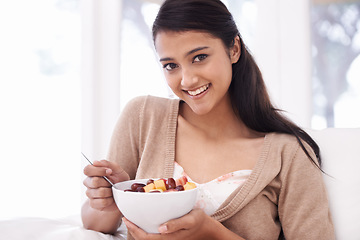 Image showing Happy woman, portrait and fruit bowl for diet, nutrition or snack sitting on sofa at home. Face of young female person, nutritionist or vegan smile with healthy breakfast for vitamin c, salad or meal