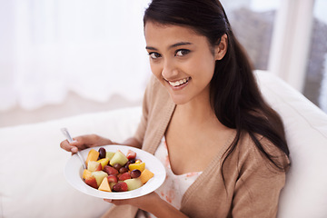 Image showing Happy woman, portrait and bowl of fruit in diet, nutrition or healthy snack on sofa at home. Face of young female person, nutritionist or vegan smile and eating breakfast for vitamin c, salad or meal