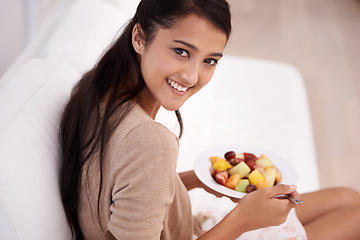 Image showing Happy woman, portrait and bowl of fruit salad for diet, nutrition or healthy snack on sofa at home. Face of young female person, nutritionist or vegan smile and eating breakfast for vitamin c or meal