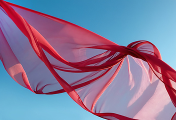 Image showing Flying transparent red fabric wave on blue background and illumi