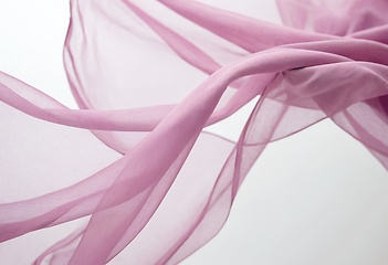 Image showing Flying pink transparent fabric wave on white background