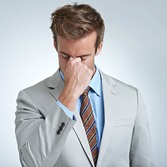 Image showing Businessman, headache and stress in studio for job, mental health and bankrupt or debt. Male person, migraine and frustrated by white background, deadline and depression or mistake and tension